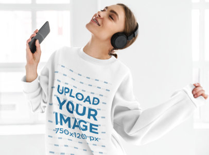 Sweatshirt Mockup of a Smiling Woman Listening to Music in Her Cellphone