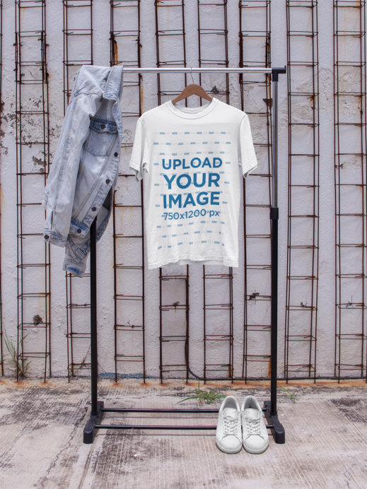 T-Shirt Mockup on a Hanger Against a White Wall