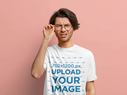 T-Shirt Mockup of a Confused Man With Glasses in a Studio