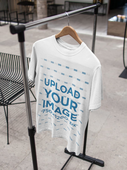 Single T-Shirt Mockup on a Hanger While Indoors a16947