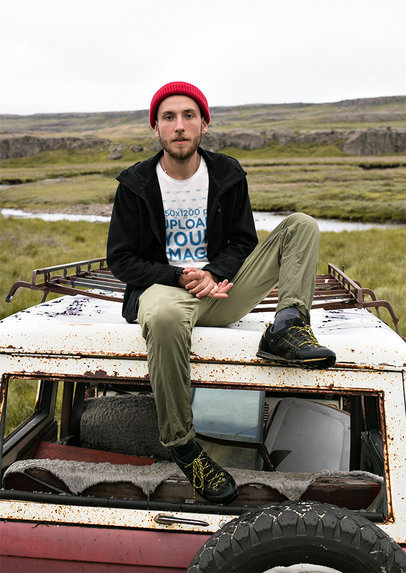 Round-Neck Tee Mockup of a Man Sitting on an Abandoned Van m9071 r-el2
