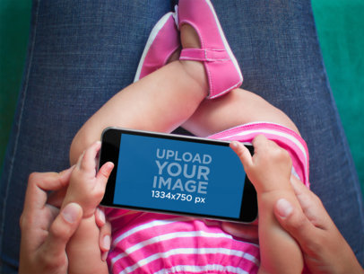 Mockup of a Baby Holding an iPhone 6