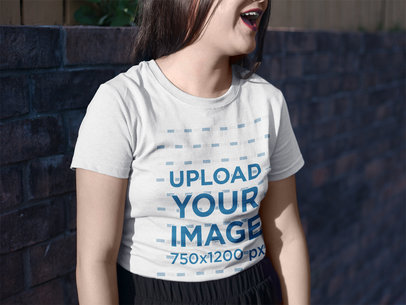 Mockup of a Woman Laughing While Wearing a Round Neck Tee Outdoors
