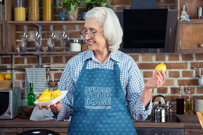 Apron Mockup Featuring a Happy Senior Woman Holding a Lemon