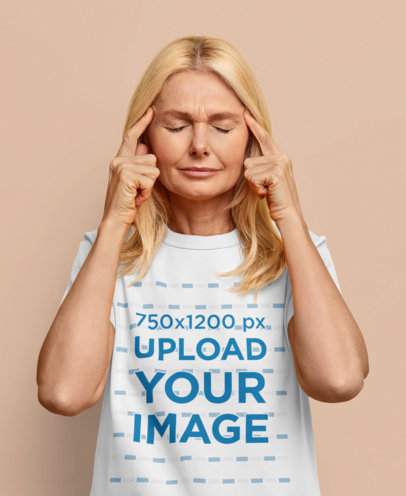 T-Shirt Mockup of a Thoughtful Middle-Aged Woman in a Studio