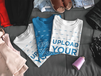 Mockup of Three T-Shirts Lying Folded on a Bed a16939
