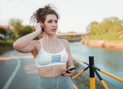 Sports Bra Mockup of a Woman with Headphones Walking by a River M8547-r-el2