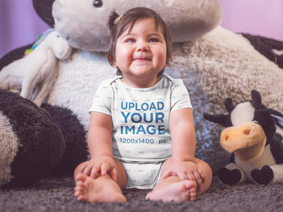 Mockup Of A Little Baby Girl Sitting Down While Smiling And Wearing A Onesie Near Her Teddy