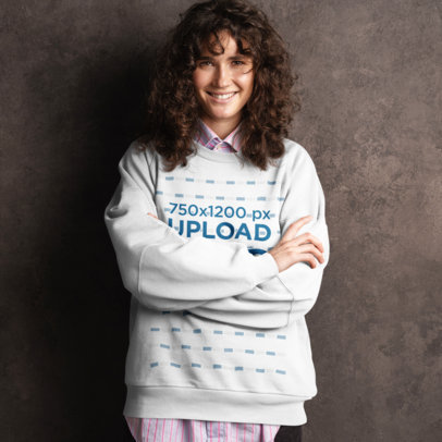 Sweatshirt Mockup Featuring a Smiling Woman Leaning over a Dark Wall