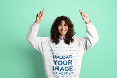 Sweatshirt Mockup Featuring a Happy Woman Pointing Up 