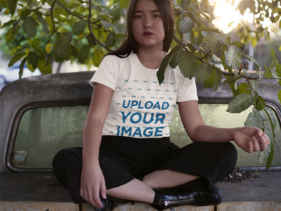 Serious Woman Wearing a T-Shirt Mockup While on top of a Truck