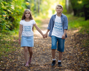 T-Shirt Mockup Featuring Boy and a Girl Holding Hands in the Woods
