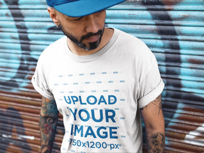 Mockup of a Middle-Aged Man Wearing a T-Shirt Against a Metal Curtain
