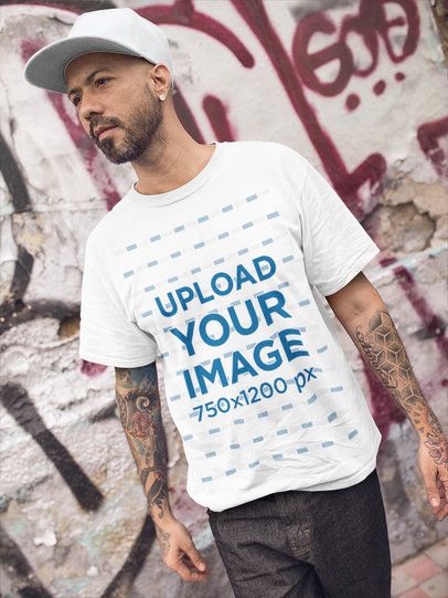 Tattooed Man Walking While Wearing a T-Shirt Mockup in an Urban Area