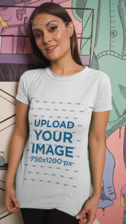 T-Shirt Video Featuring a Young Woman Posing Against a Street Art Mural