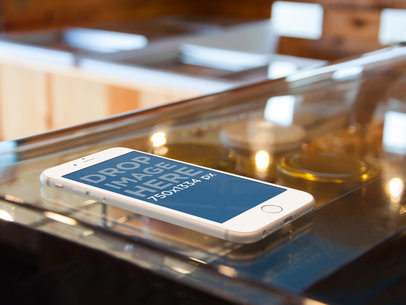 Mockup of an iPhone 6 at a Bakery Shop