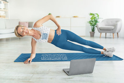 Sports Bra and Yoga Mat Mockup of a Happy Woman Training With a Fitness Video Tutorial