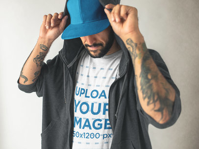 Middle Aged Tattooed Man with a Hat Wearing a Round Neck Tee Mockup and a Hoodie