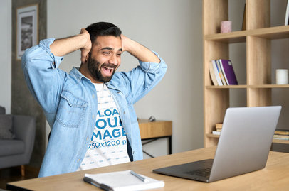 T-Shirt Mockup Featuring a Man Looking Excited at His Laptop m9813 r-el2