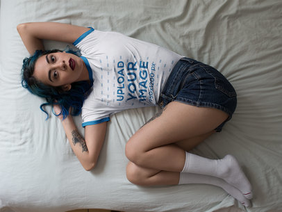 Edgy Woman Wearing a Ringer T-Shirt Mockup While Lying on a Bed