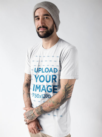 Portrait of a Tattooed Man With a Beard Wearing a T-Shirt Mockup Against a White Background