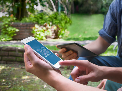 Mockup of Two Friends Hanging Out and Using an iPhone 6
