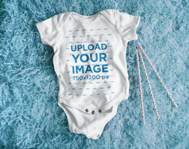 Mockup of a Baby Onesie Flat Laid over a Furry-Textured Surface m8632 r-el2