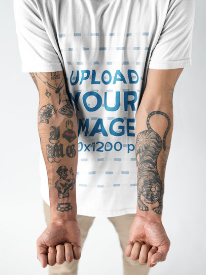 Closeup of Tattoos in a Mans Arms While Wearing a Round Neck T-Shirt Mockup