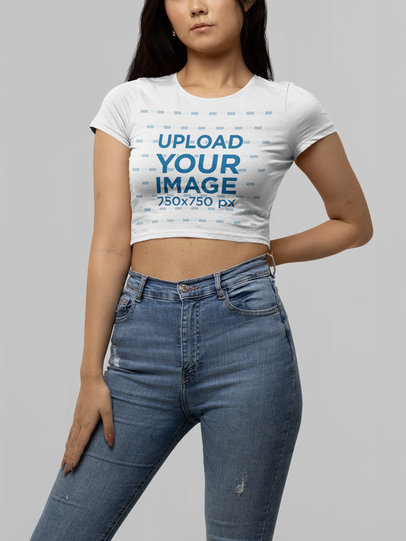 Mockup of a Young Woman Wearing a Bella Canvas Crop Top in a Studio