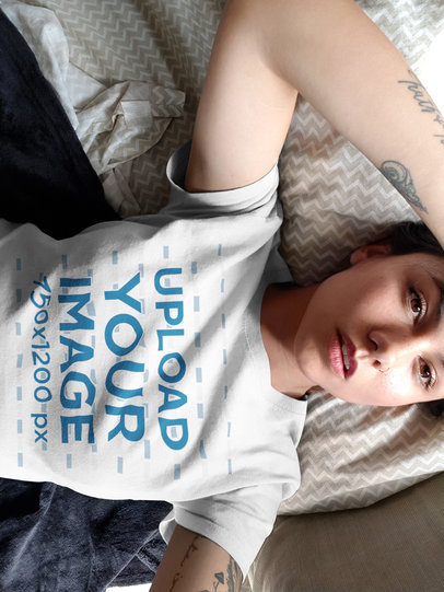 Selfie Mockup of a Woman Wearing a Round Neck Tee on her Bed