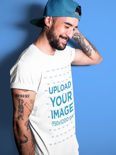 Happy Middle Aged Tattooed Guy Wearing a T-Shirt Mockup at a Studio