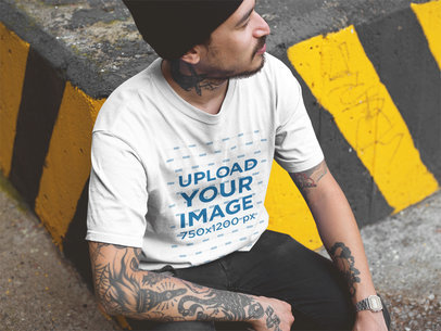 Mockup of a Tattooed Man Wearing a T-Shirt While at an Urban Area