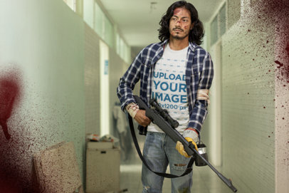 T-Shirt Mockup Featuring a Man Holding a Sniper Rifle at an Abandoned Building
