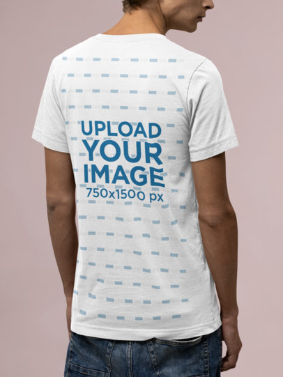 Back-View Mockup of a Man Wearing a Bella Canvas T-Shirt at a Studio