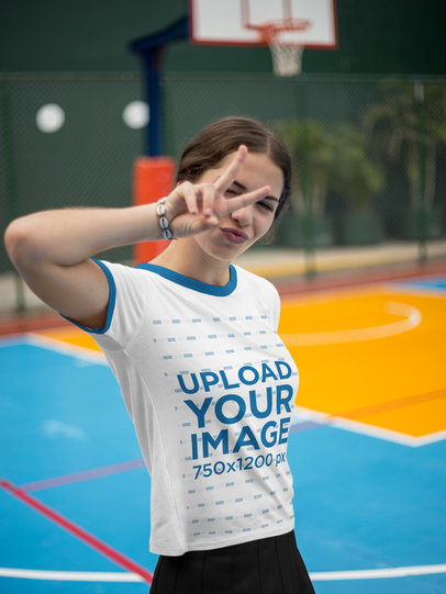 Woman Wearing a Ringer Tshirt Mockup at a Court While Doing a Peace and Love Sign
