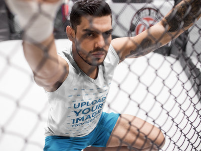 Sports Mockup of a MMA Fighter Holding the Cage While Wearing a Sleeveless Shirt
