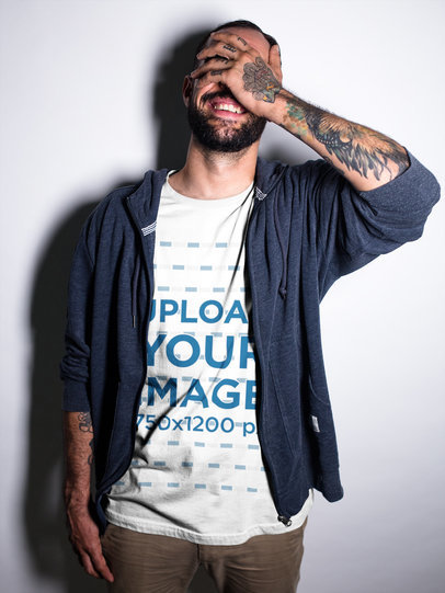 Smiling Tattooed Man Wearing a T-Shirt While at a Studio Mockup