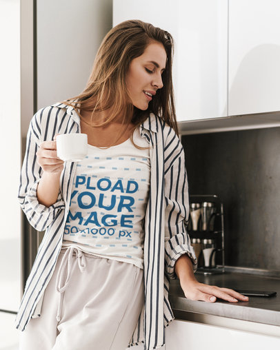 T-Shirt Mockup of a Woman Having a Coffee at Home