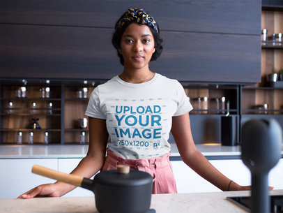Woman Wearing a Round Neck Tshirt Mockup While in her Kitchen Counter