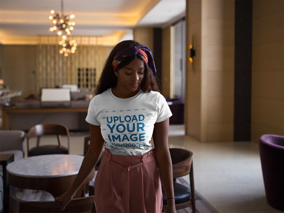 Mockup of a Woman Wearing a T-Shirt While Walking in the Hotel Lobby 17131
