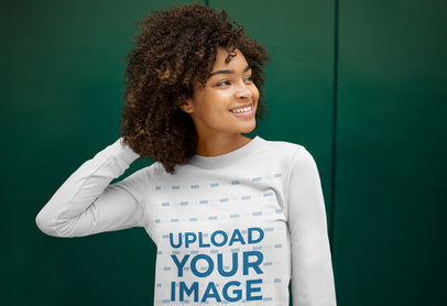 Sweatshirt Mockup Featuring a Joyful Young Woman Against a Green Wall m16886-r-el2