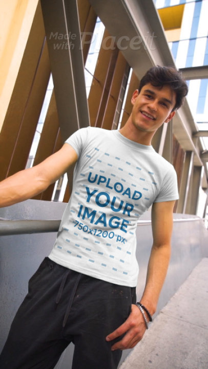 T-Shirt Video of a Young Man Posing by a Modern Building