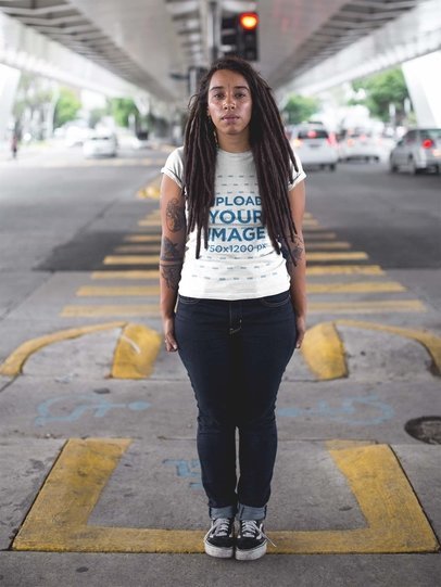 Woman with Locs Wearing a Round Neck Tee Mockup While Under a Bridge