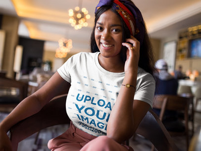 Smiling Beautiful Woman Wearing a T-Shirt Mockup While Inside a Hotel Lobby a17129