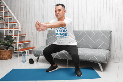 Activewear Mockup of a Man Wearing a Basic Tee While Exercising at Home