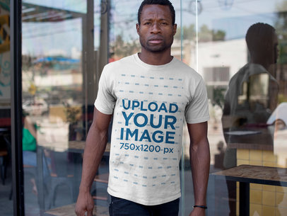 Man Wearing a Tshirt Mockup While Coming out of a Restaurant