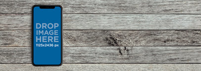 iPhone 11 Pro Mockup Lying Over a Gray Wooden Surface