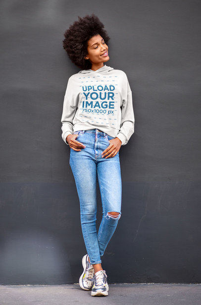 Pullover Hoodie Mockup of a Happy Woman Leaning Against a Wall