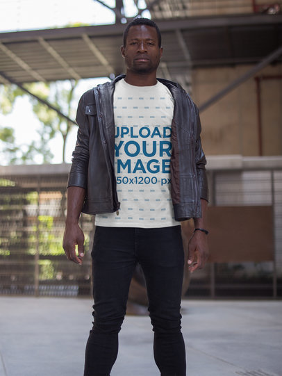 Guy Wearing a Tshirt Mockup While on top of a Building