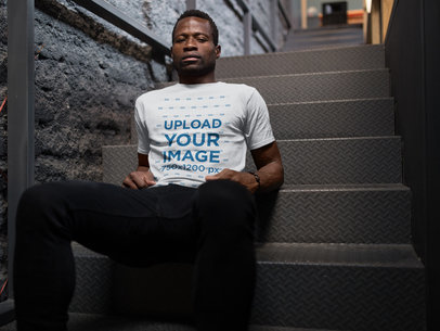 Man Sitting on Stairways While Wearing a Tshirt Mockup